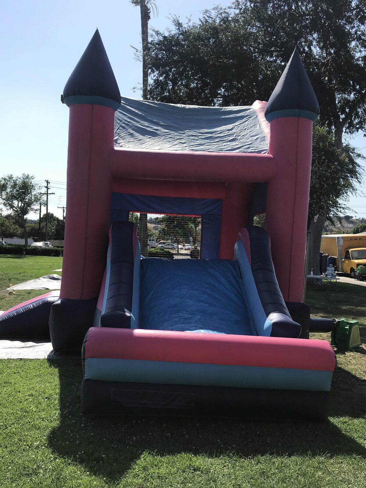 2n1 pink princess combo bounce house rental in San Diego, end view of the slide lane between the pink towers