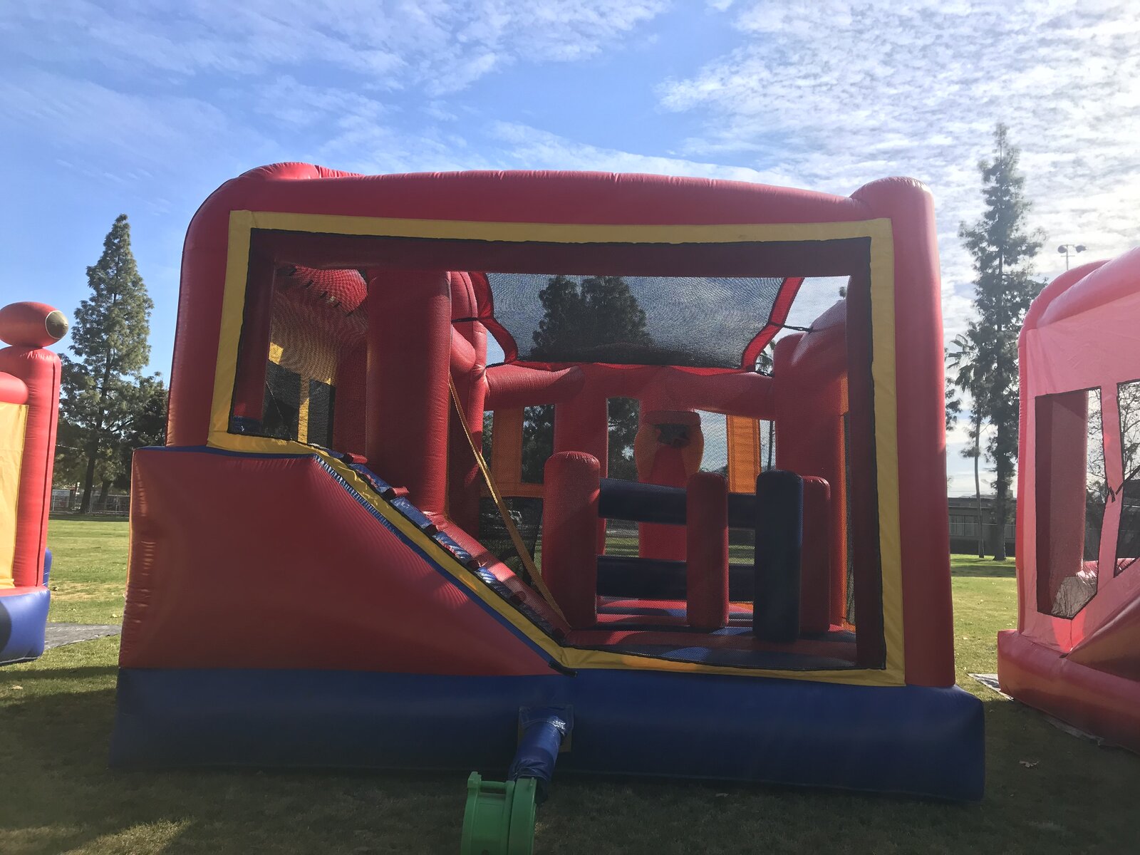 5n1 blue banner combo bounce house rental in San Diego, open front view of the interior slide, climb-up and pop-up obstacles