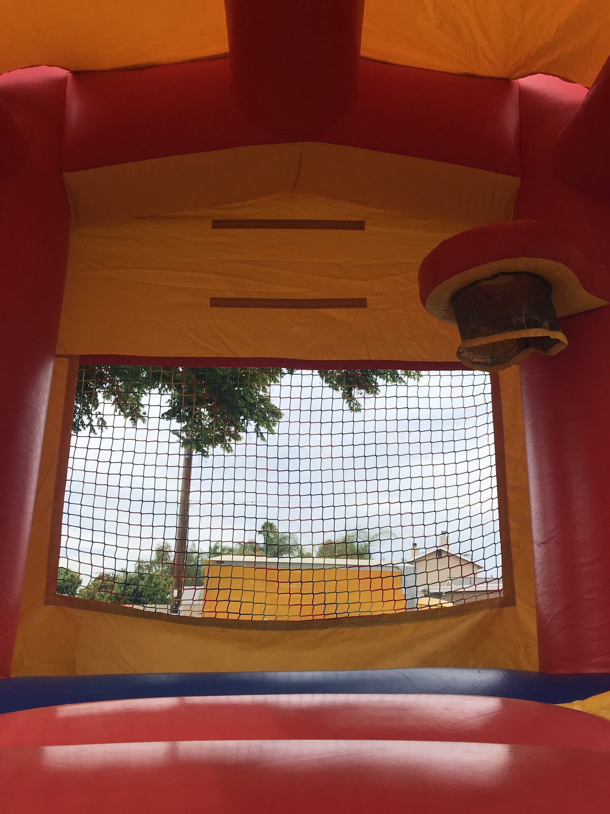 12x14 blue castle banner mini bounce house rental in San Diego, interior close-up of the mesh window and hoop