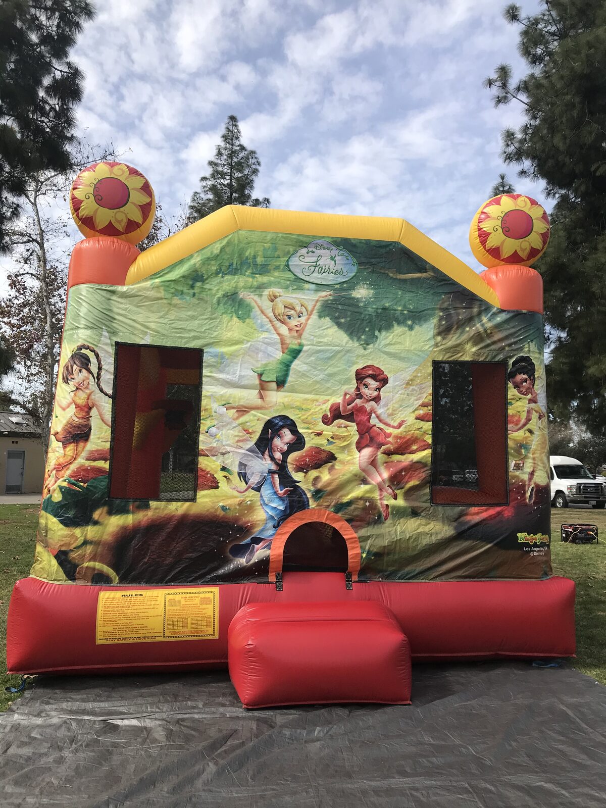4n1 fairies combo bounce house rental in San Diego, straight-on front view of the entry step and posted rules panel on a tarp