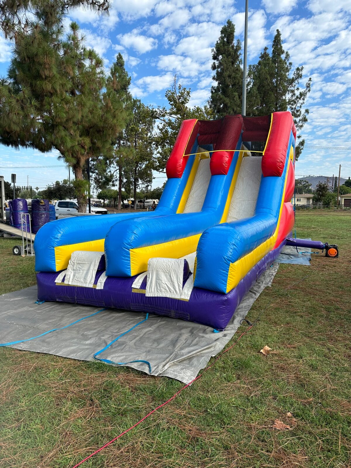 18ft dual lane monster obstacle course rental in San Diego, wide view of the twin slide lanes on grass