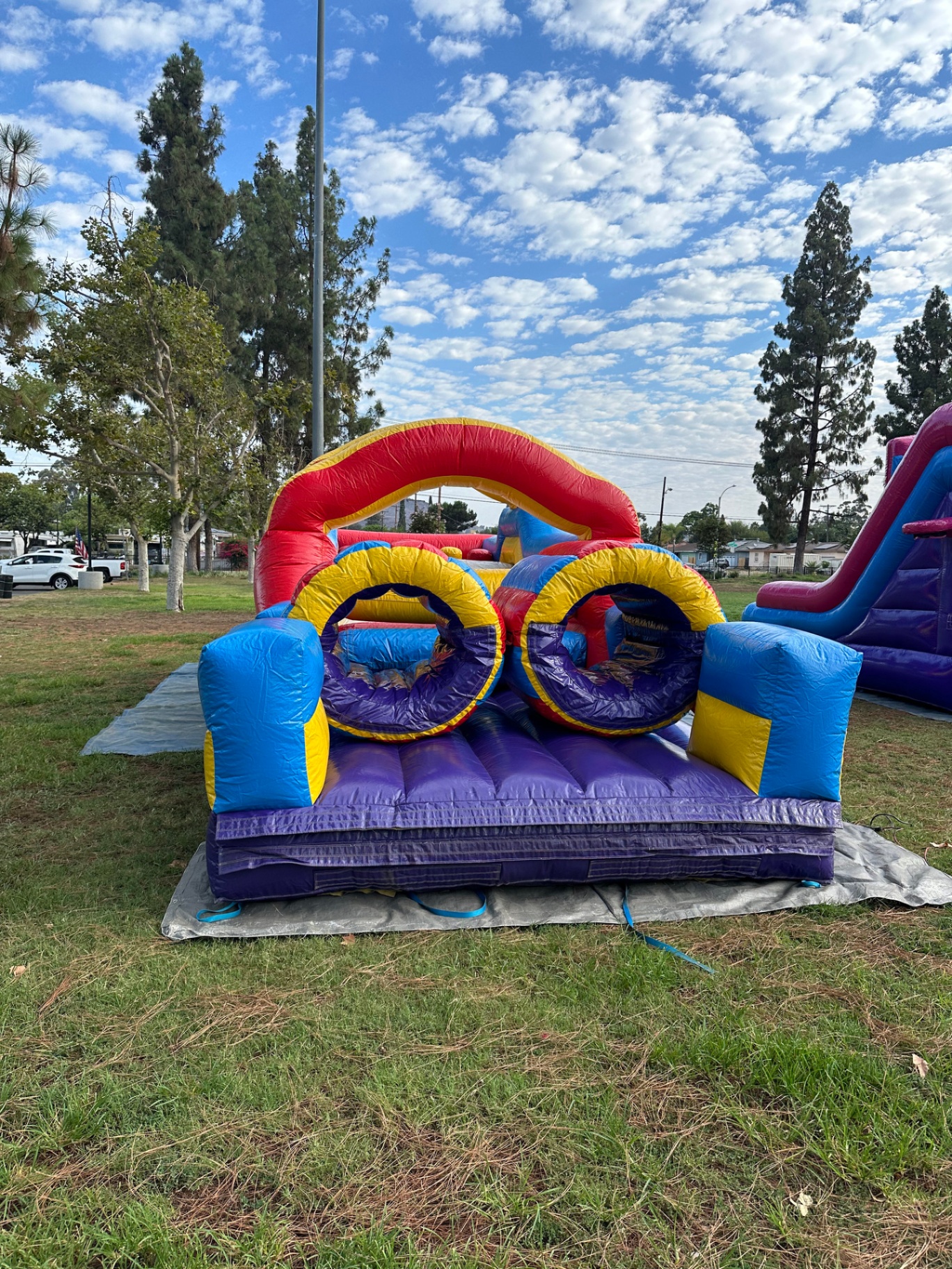 33ft monster obstacle course rental in San Diego, straight-on entry view of the twin tunnels under the red arch