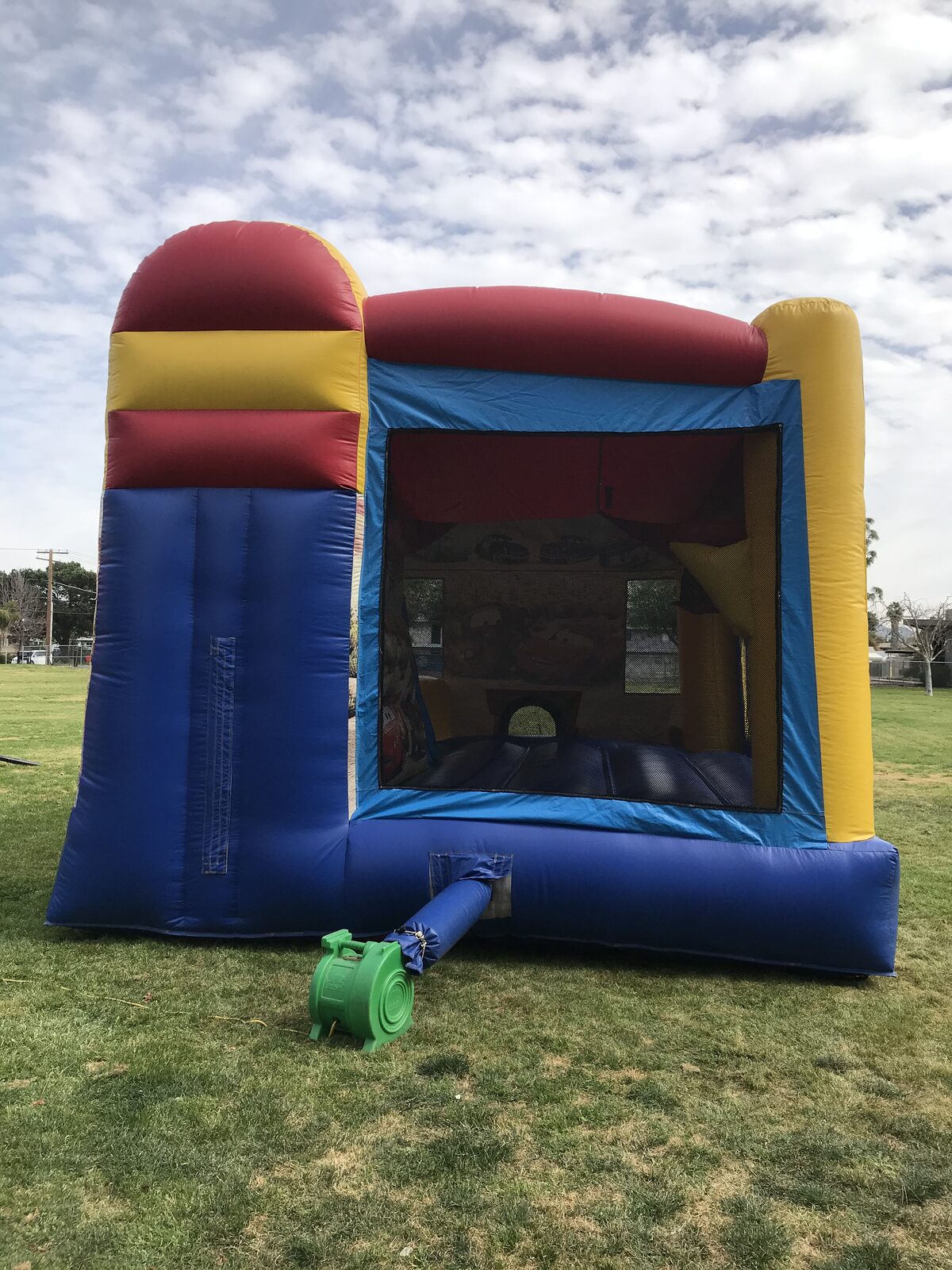 4n1 cars combo bounce house rental in San Diego, three-quarter view showing the entry step-up and side slide