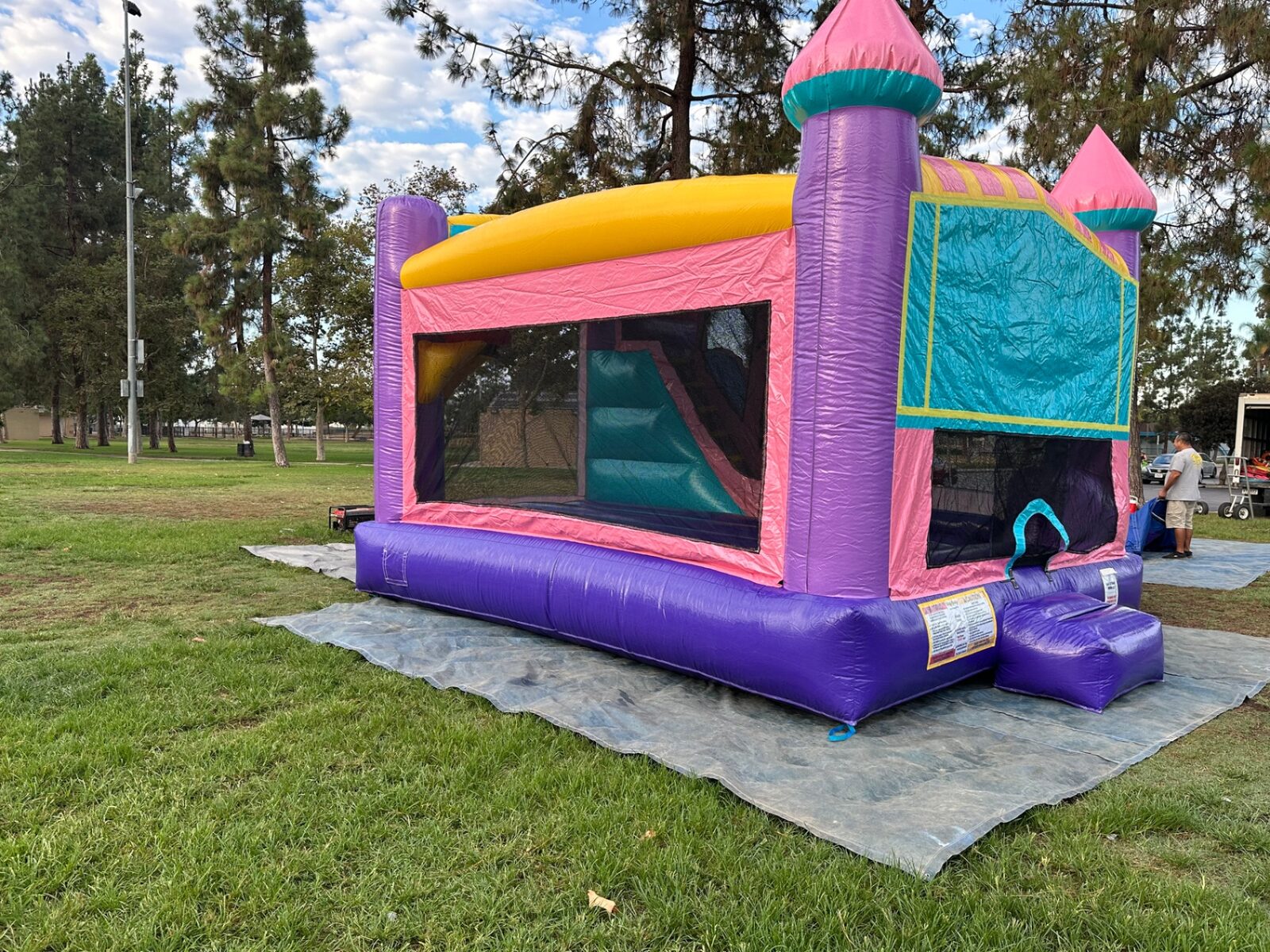 4n1 dazzling castle combo bounce house rental in San Diego, rear-side view of the yellow roof and pink side wall with the slide chamber visible
