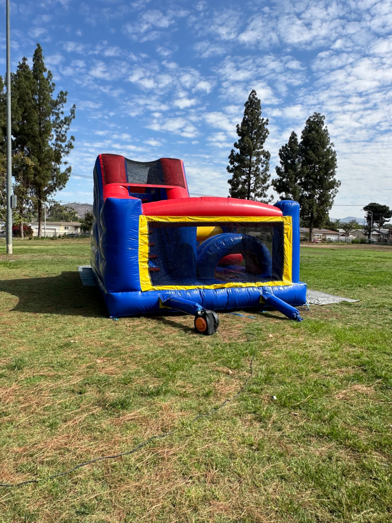 Challenge course obstacle rental in San Diego, blue and red lane, end view showing the blower hookup and interior arch obstacle