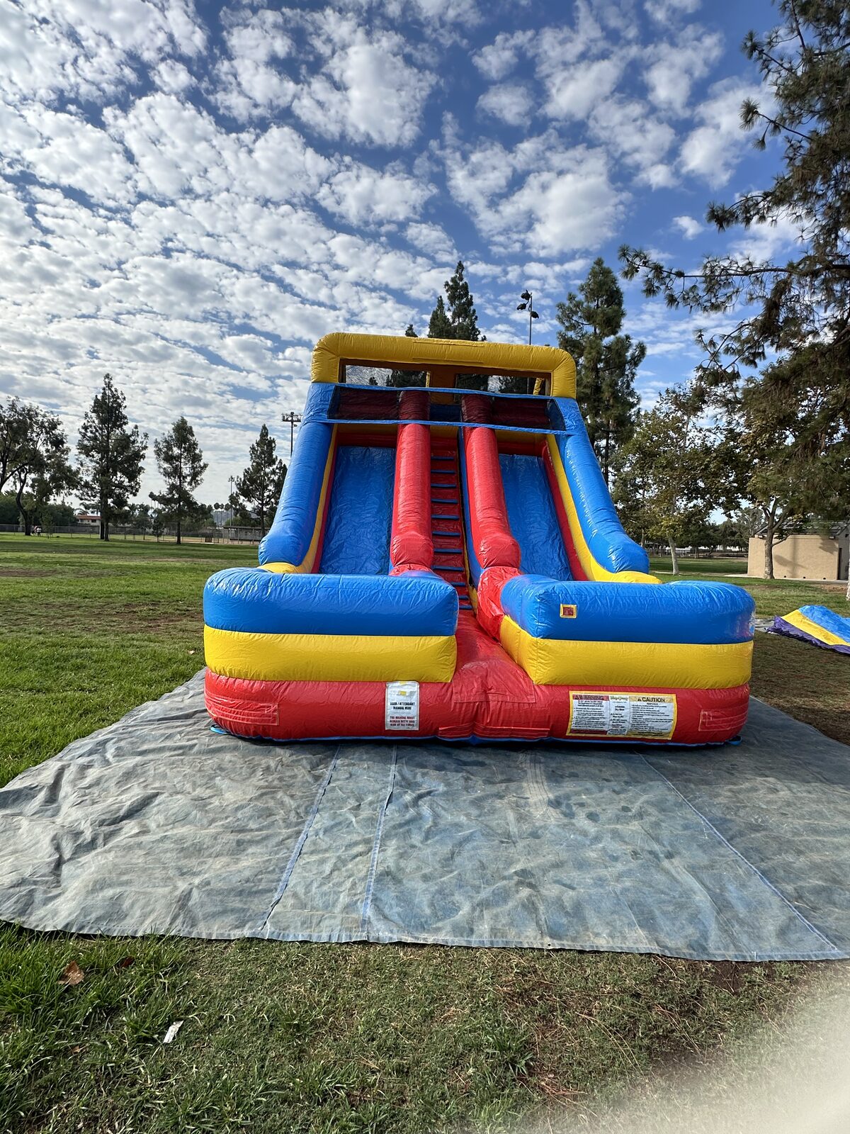 Dry slide rental in San Diego, 18ft dual lane slide angled view showing both racing lanes
