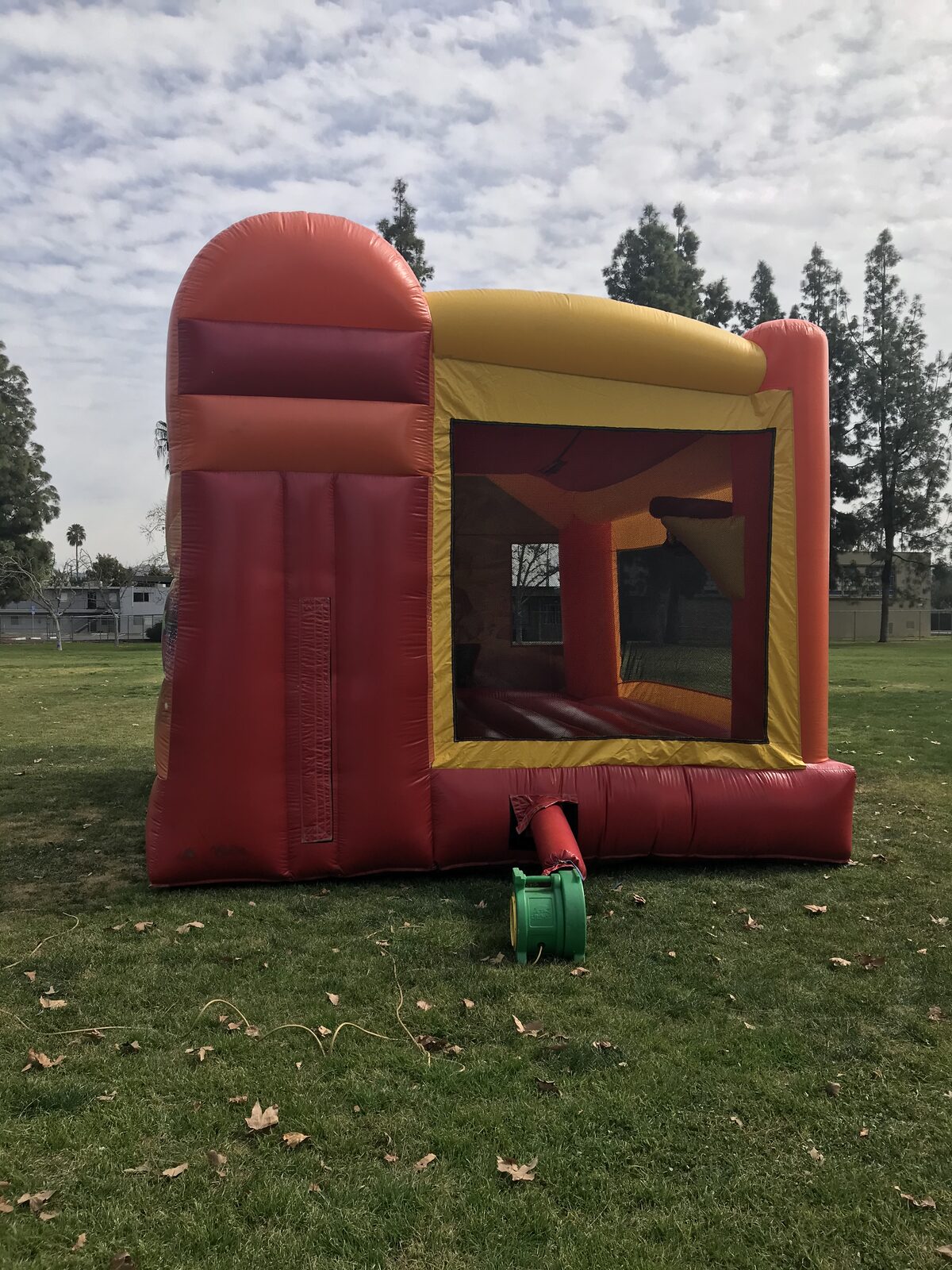 4n1 fairies combo bounce house rental in San Diego, side view showing the mesh safety window and the enclosed slide chamber