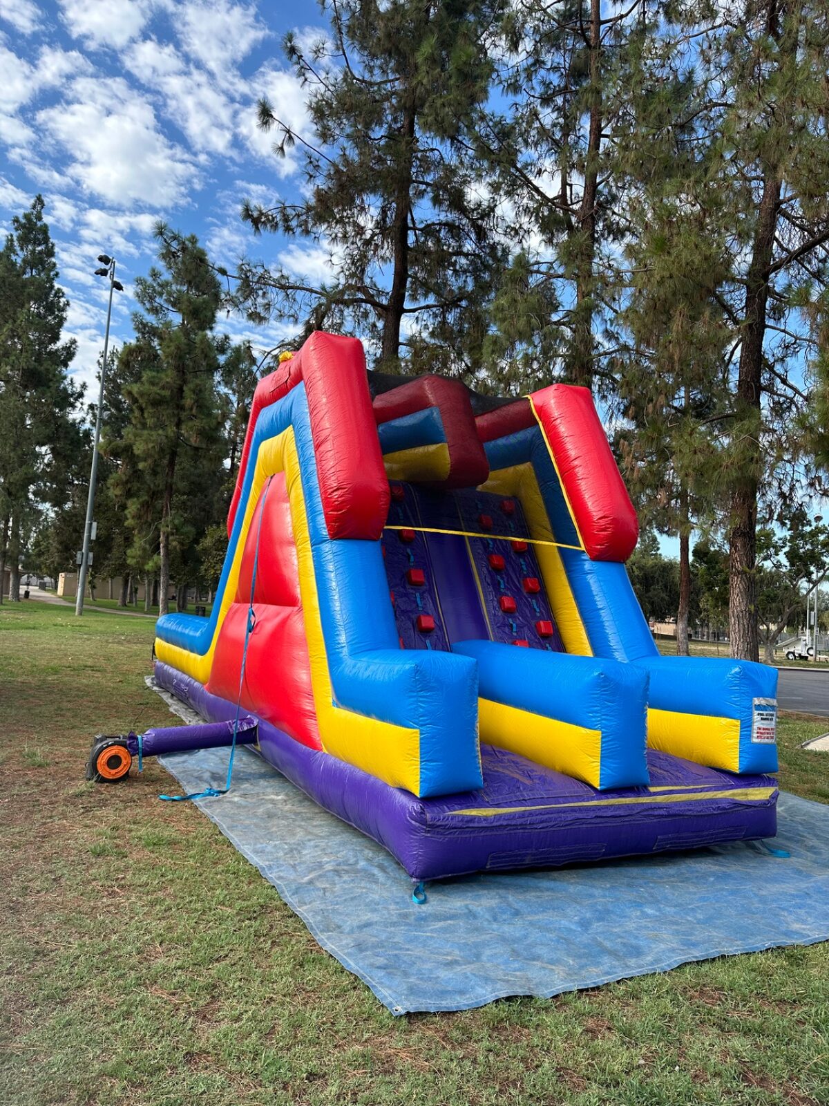 18ft dual lane monster obstacle course rental in San Diego, full side profile showing the climb wall and blower