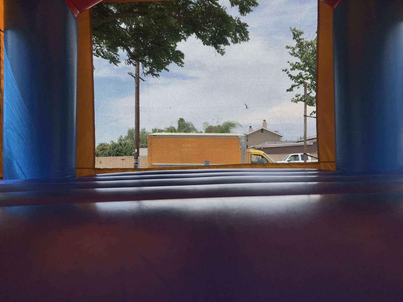 13x13 Justice League bounce house rental in San Diego — close view of the superhero art panel and entry ramp