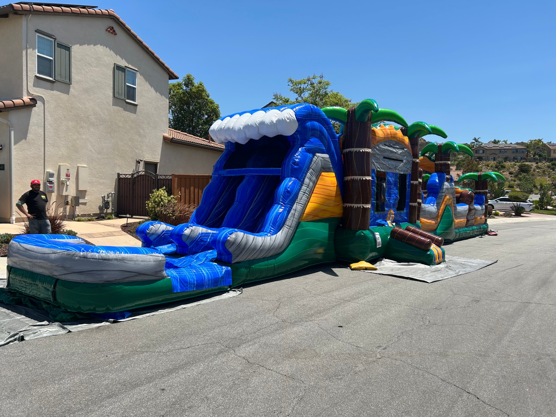 63ft tropical obstacle course rental in San Diego, residential setup showing the slide and course length