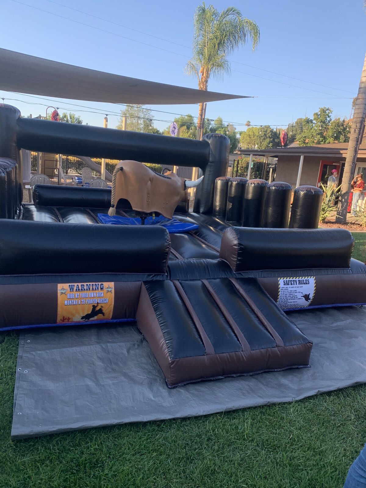 Mechanical bull rental in San Diego, 13x13 setup close-up of the bull, safety rules banner and padded mat