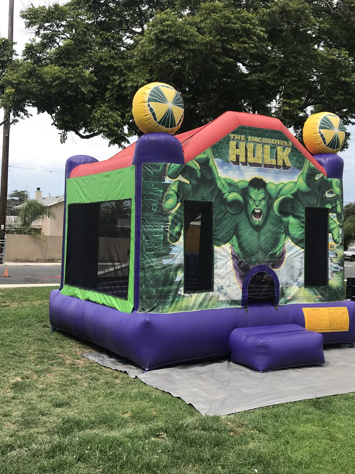 13x13 Incredible Hulk bounce house rental in San Diego — side and front view showing the green mesh side walls and entry ramp