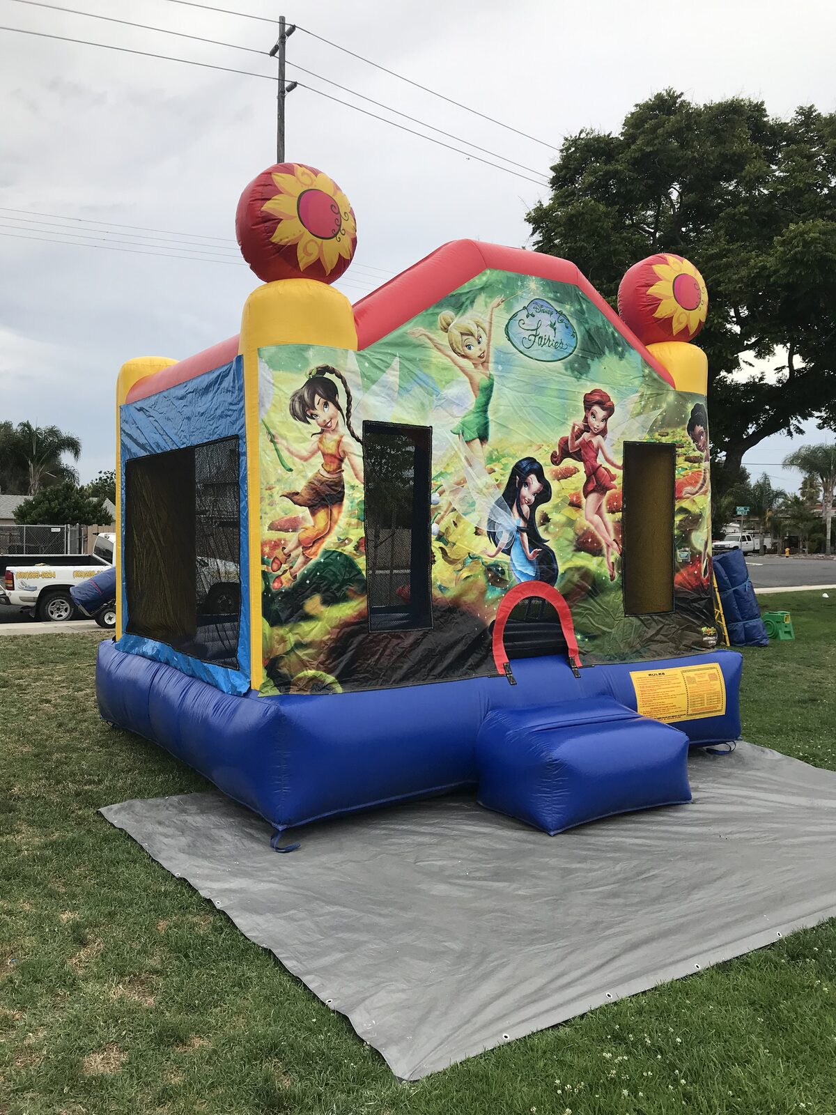13x13 Disney's Fairies bounce house rental in San Diego — side view showing mesh windows and the safety ramp entrance