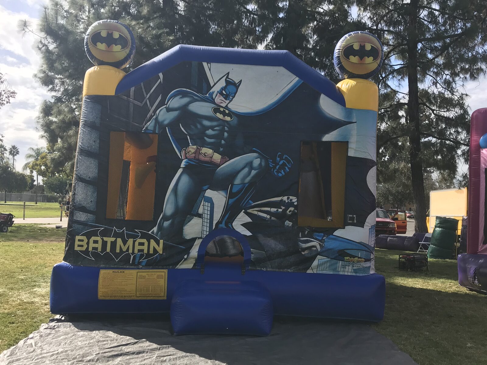 4n1 Batman combo bounce house rental in San Diego, straight-on view of the Batman panel and blue entry ramp