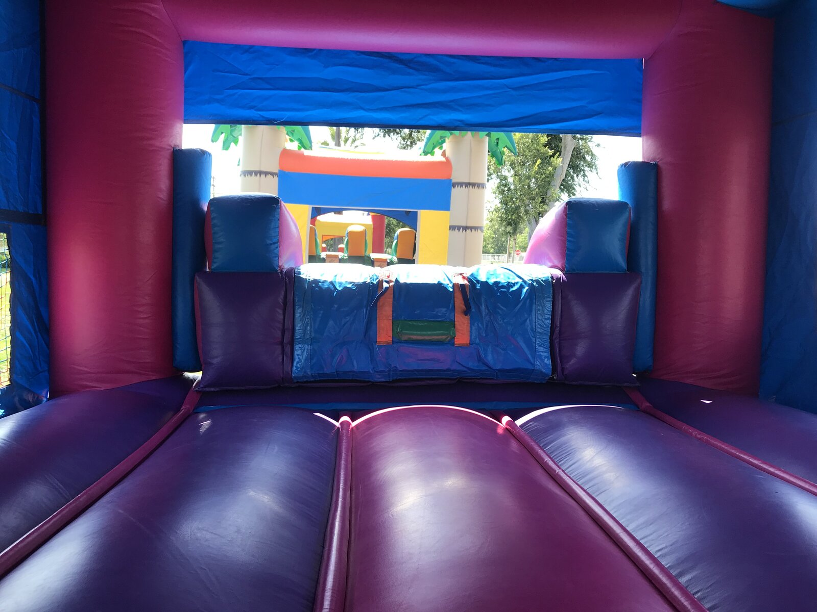 2n1 pink castle banner combo bounce house rental in San Diego, interior view looking out through the open front toward the jump area