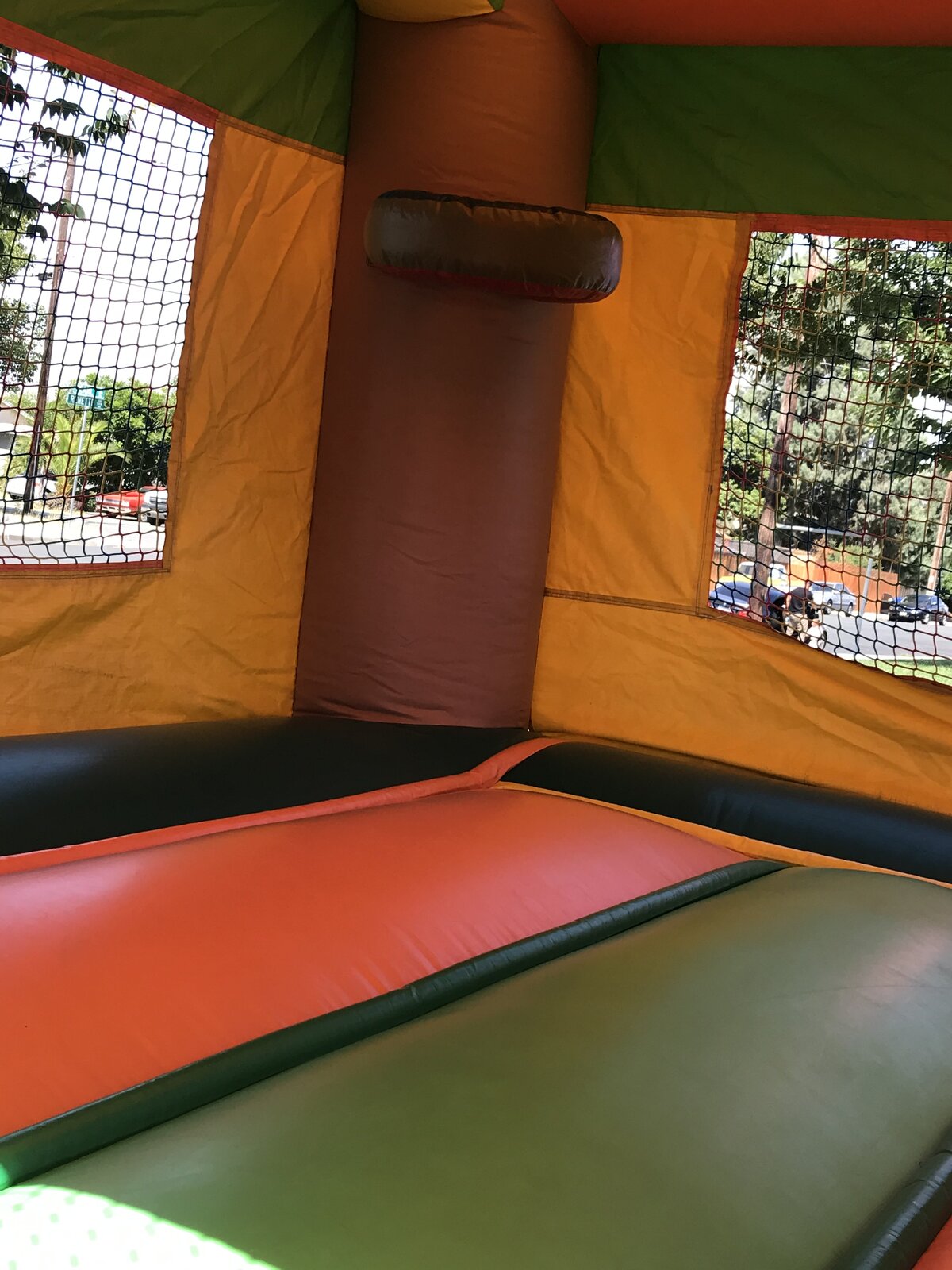 2n1 palm tree combo bounce house rental in San Diego, interior view of the padded jump floor, palm trunk column, and mesh windows