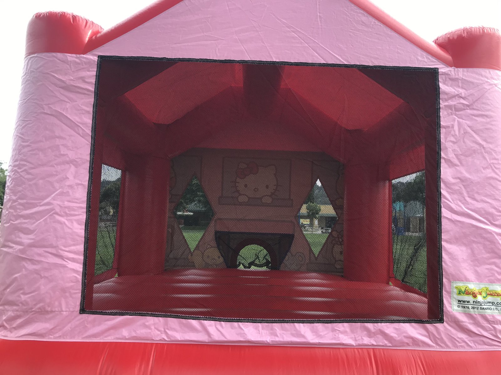 13x13 Hello Kitty bounce house rental in San Diego — close view through the front mesh safety netting into the jumping area