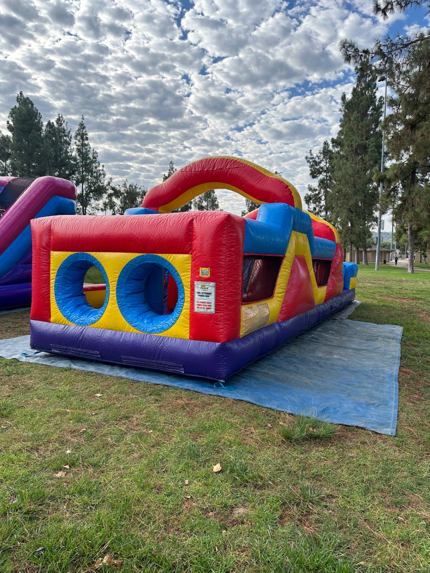 33ft monster obstacle course rental in San Diego, side view showing the double tunnel windows and red arch
