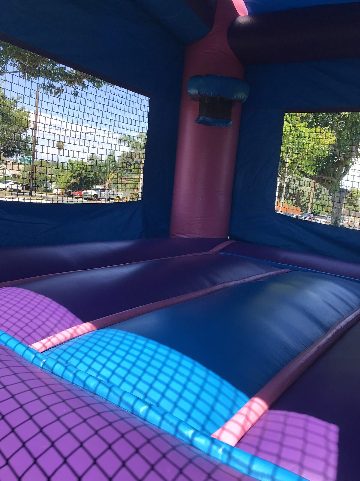 2n1 pink castle banner combo bounce house rental in San Diego, interior view of the padded jump floor, basketball hoop and mesh safety netting