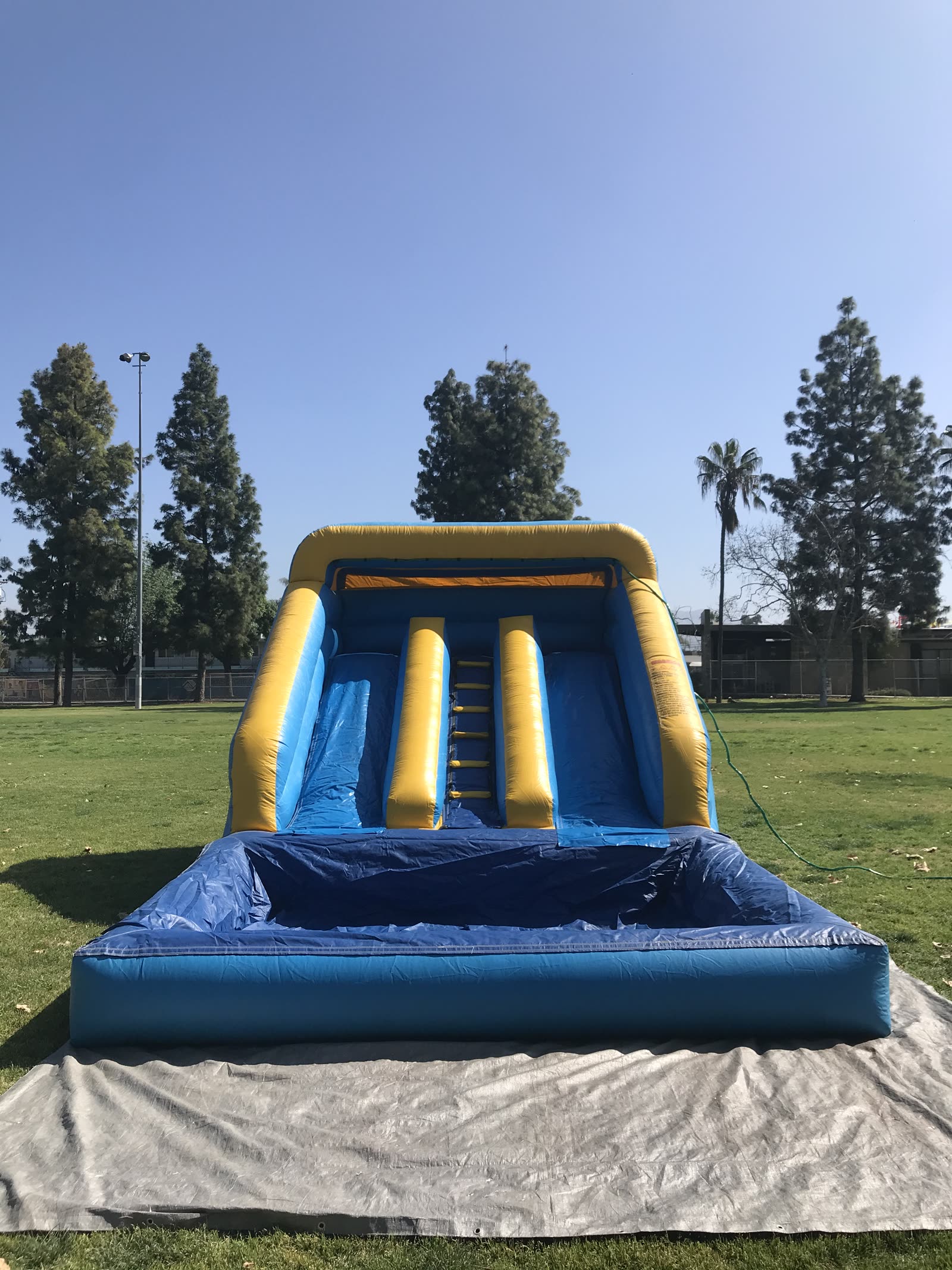 Mini water slide rental in San Diego, 12ft mini dual lane slide straight-on view showing both racing lanes and the center climb