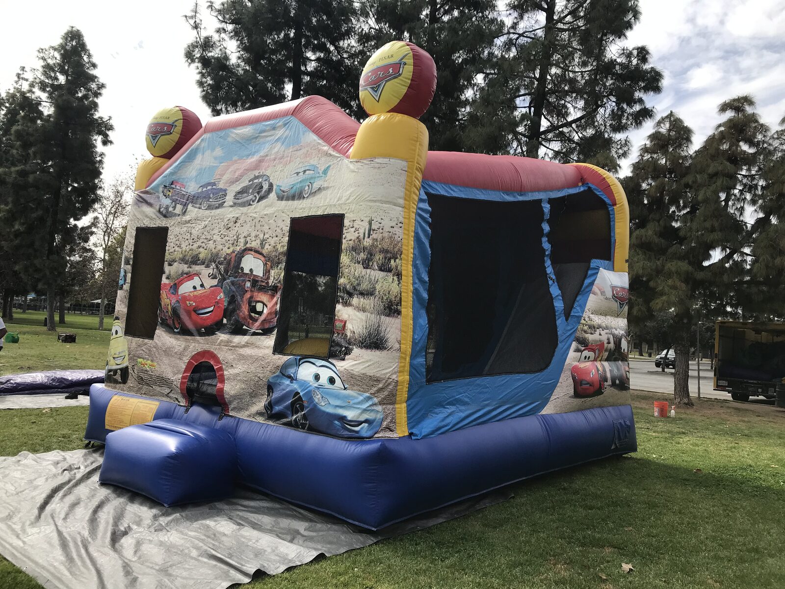 4n1 cars combo bounce house rental in San Diego, side view of the slide lane and landing bumper