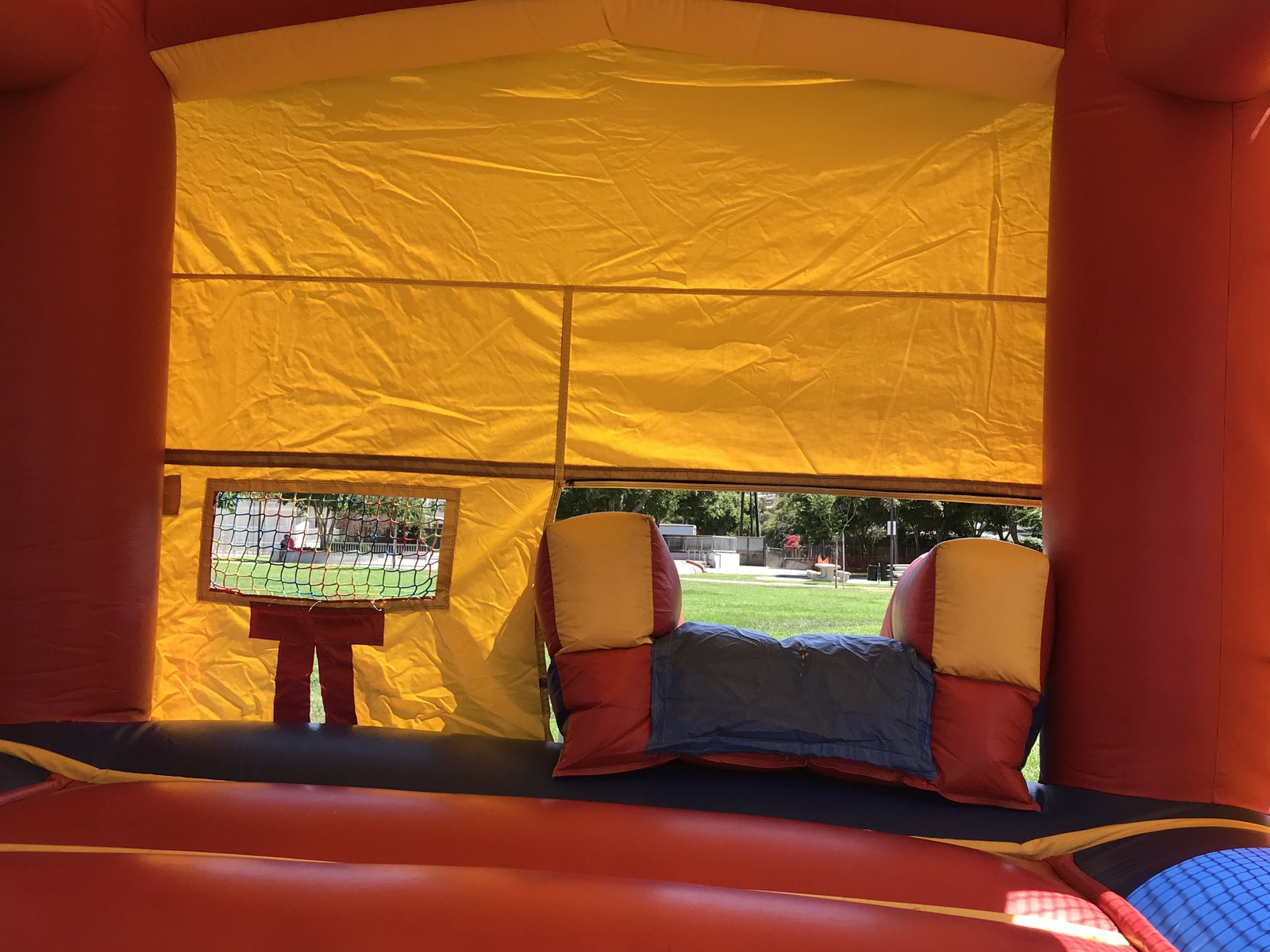 2n1 blue castle combo bounce house rental in San Diego, view from inside the jump area looking out through the slide exit
