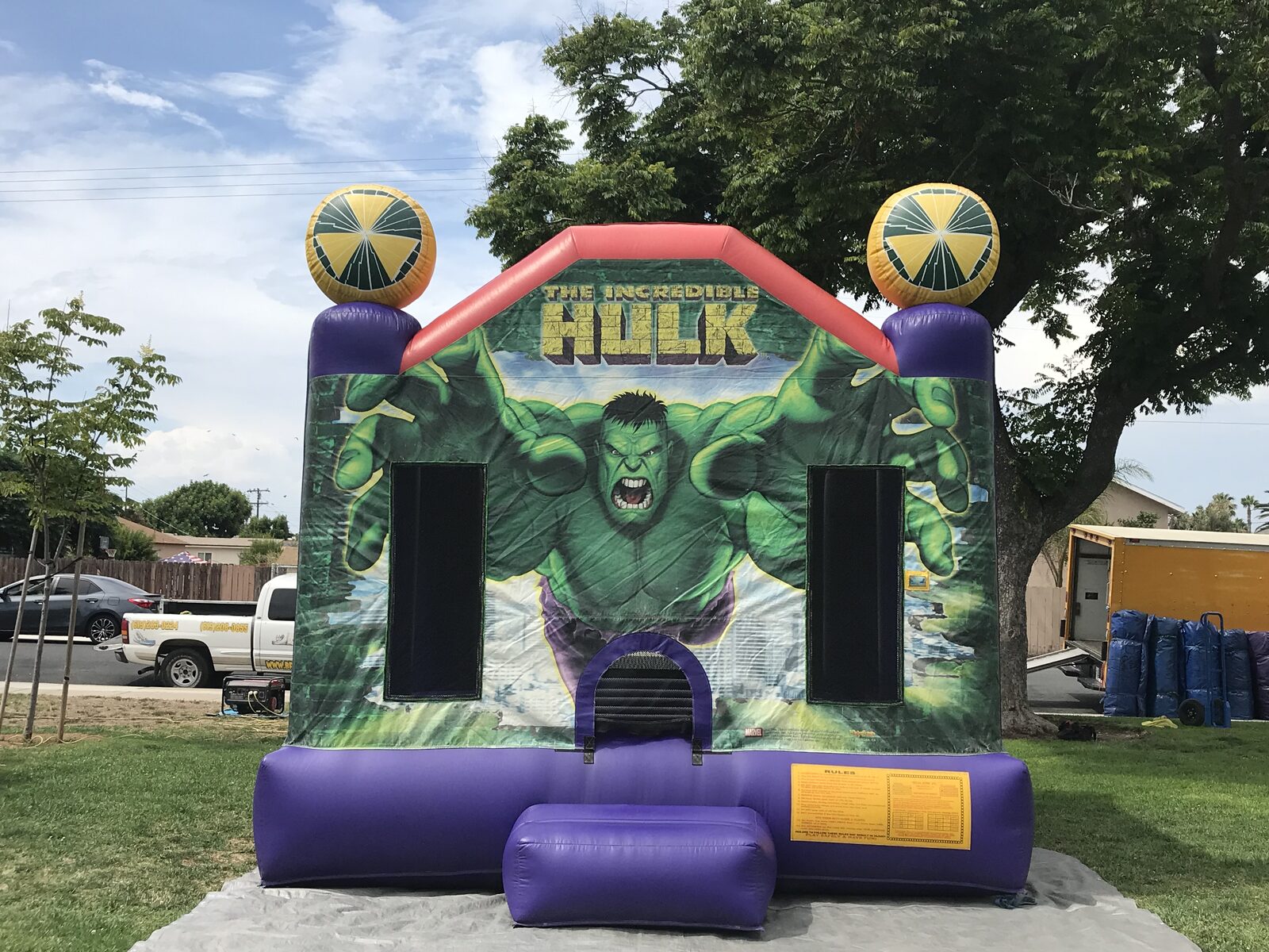 13x13 Incredible Hulk bounce house rental in San Diego — straight-on front view of the green Hulk art panel with purple base and basketball-topped corner posts