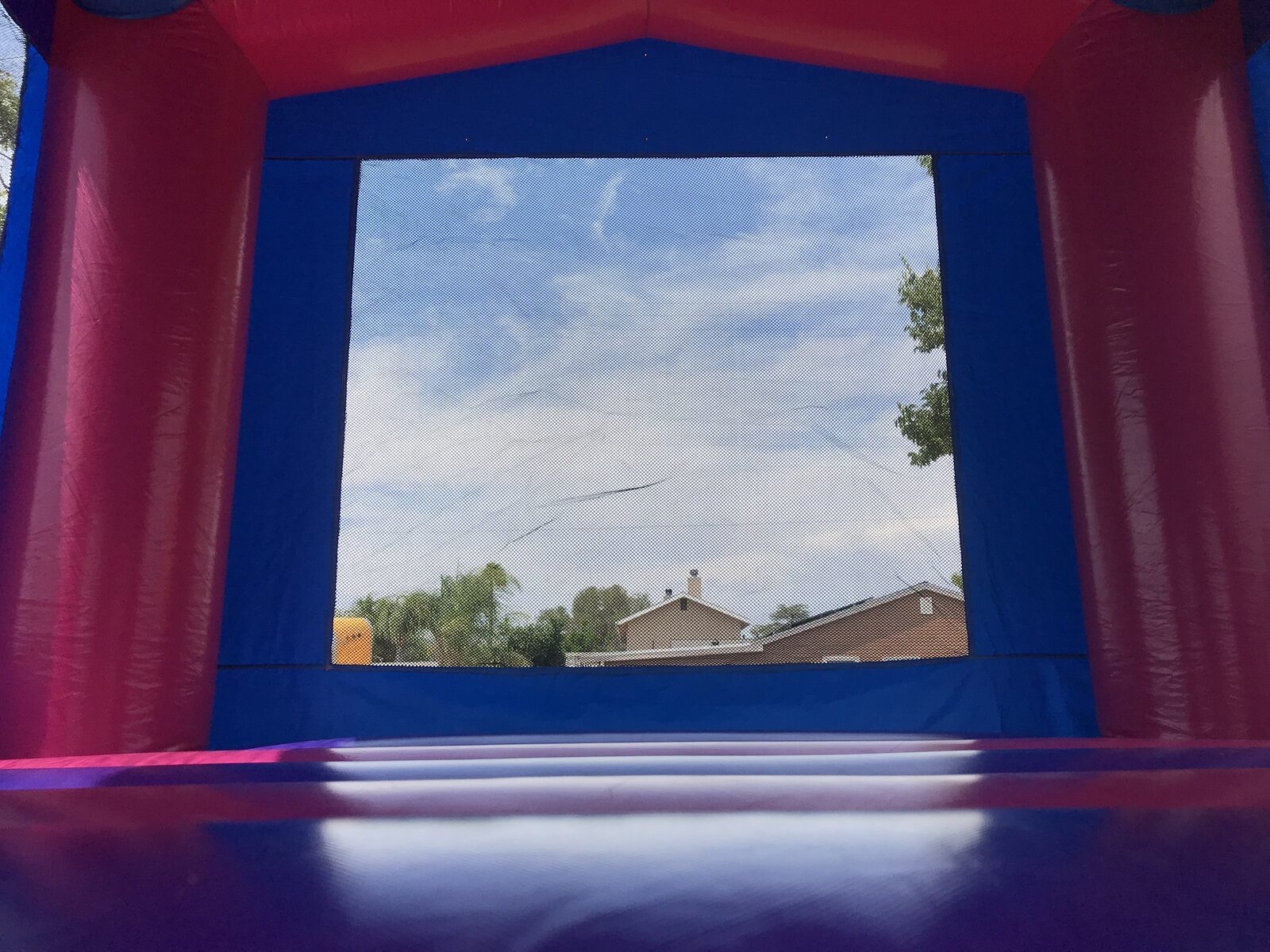 13x13 pink banner bounce house rental in San Diego — inside view of the pink and purple jumping floor and large mesh safety window
