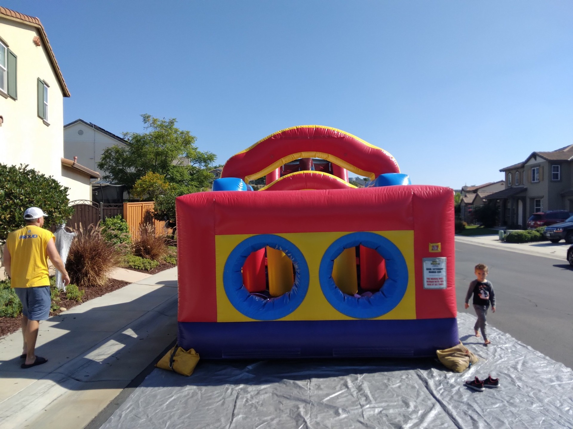 70ft monster obstacle course rental in San Diego, front entry view of the twin round crawl-through tunnels on a tarp