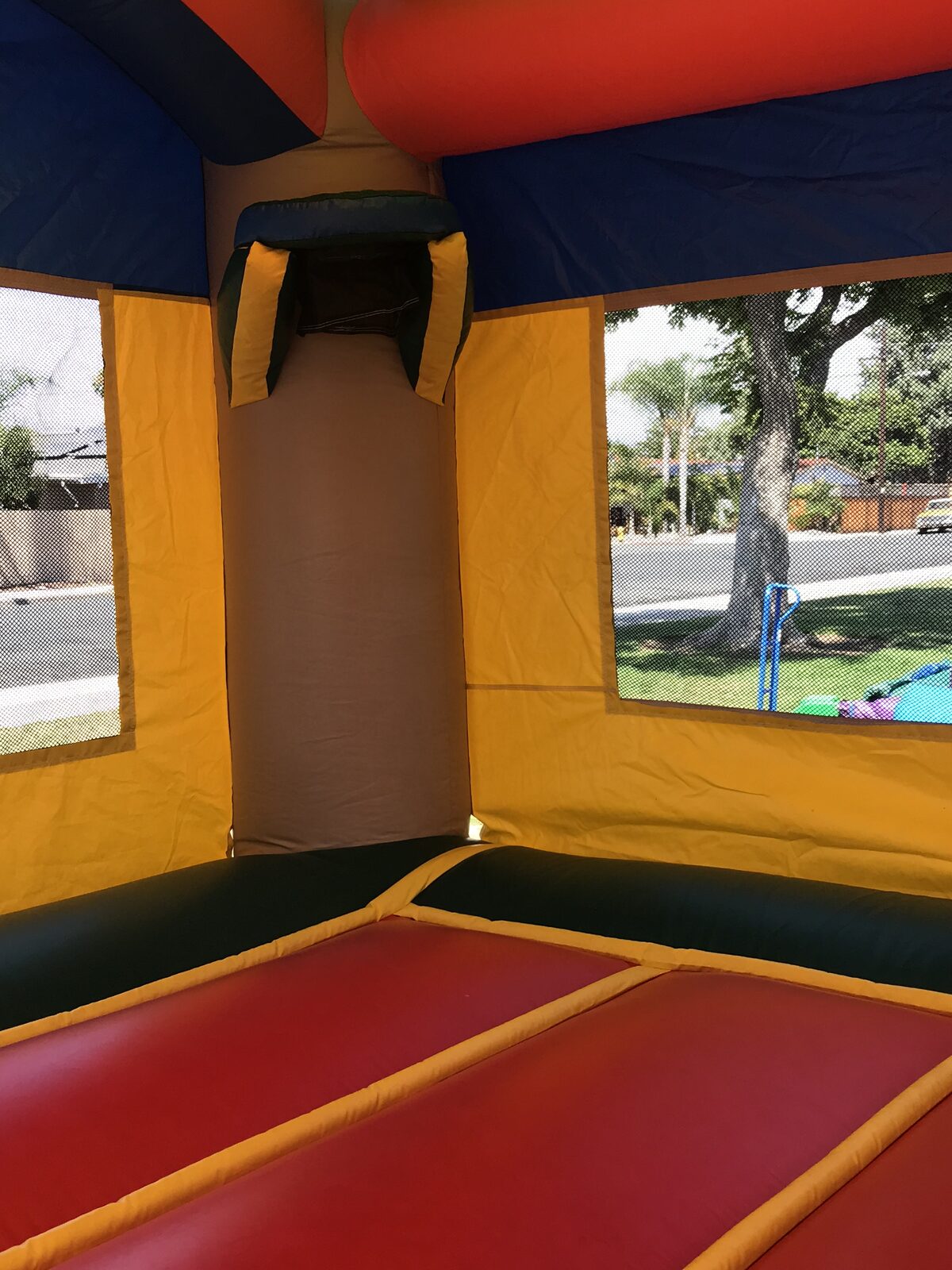 3n1 palm tree combo bounce house rental in San Diego, interior view of the padded jump floor and basketball hoop