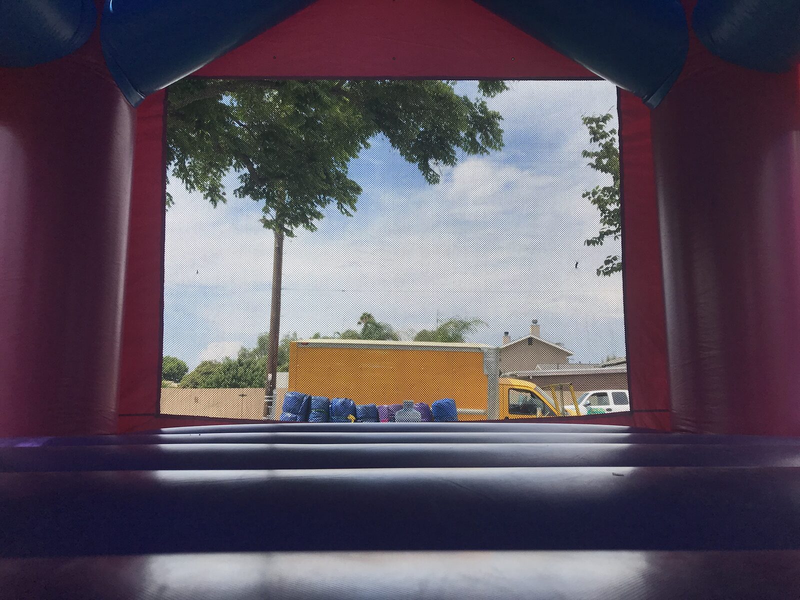 13x13 Disney Princess bounce house rental in San Diego — interior view looking out the mesh window from the purple jumping floor