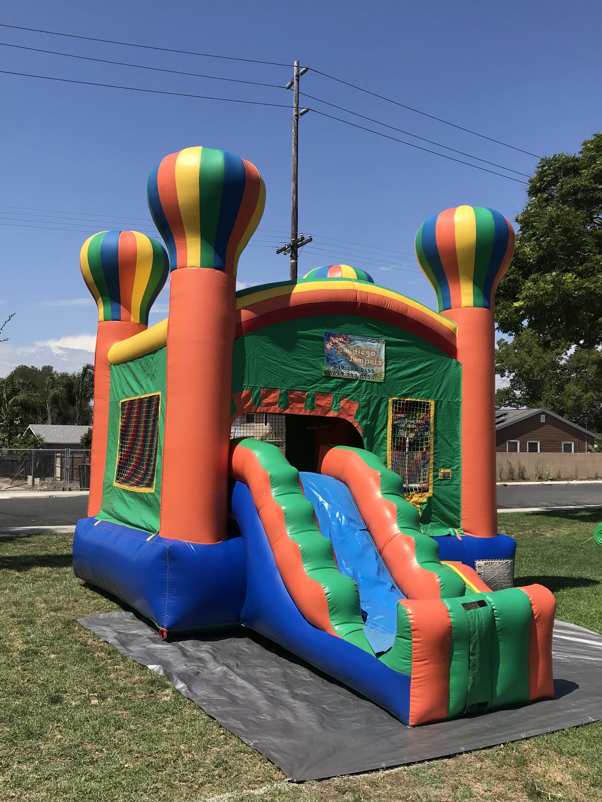 2n1 summer balloon combo bounce house rental in San Diego, front view showing the entry step-up and slide lane on the tarp