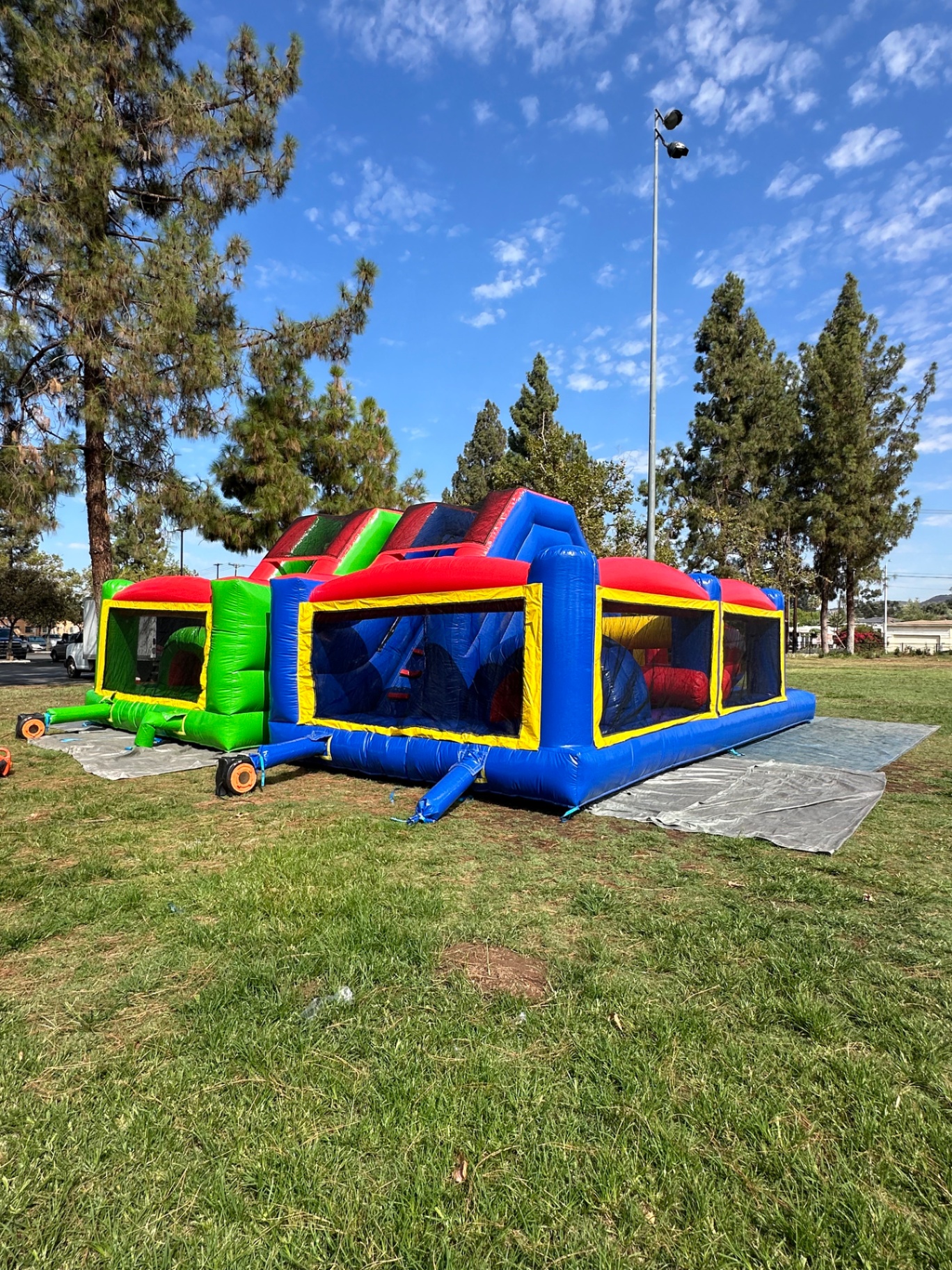 Dual lane challenge course obstacle rental in San Diego, wide rear view of the paired lanes on tarps at a park field