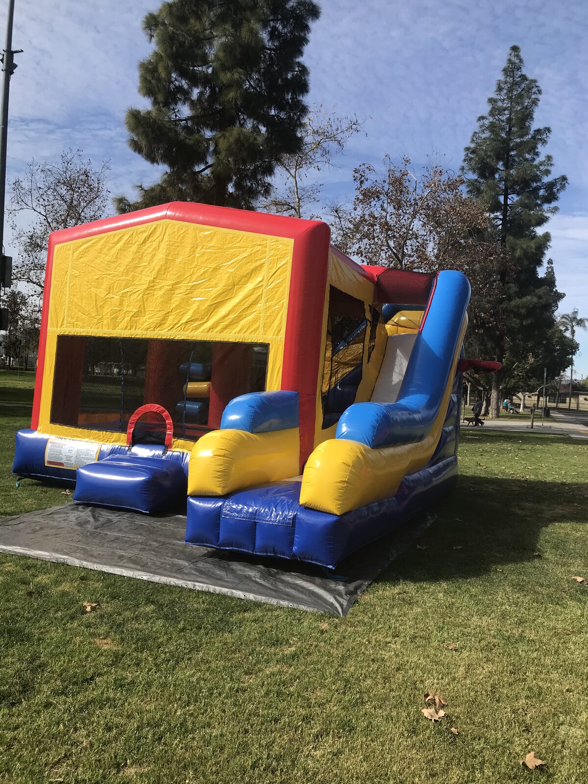 6n1 banner combo bounce house rental in San Diego, three-quarter view showing the blank banner panel and step-up entry