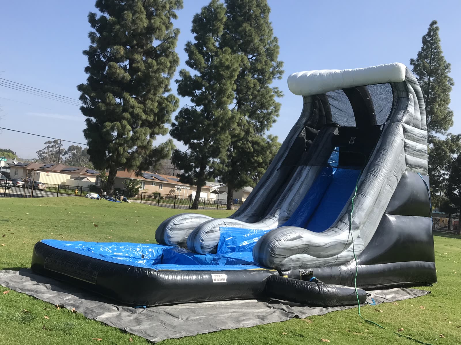 Water slide rental in San Diego, 18ft wave setup wide view with the tarp under the pool