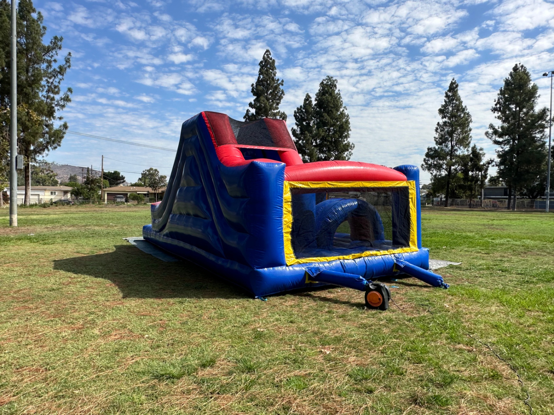 Challenge course obstacle rental in San Diego, blue and red lane, angled view of the slide ramp with the obstacle bay in front