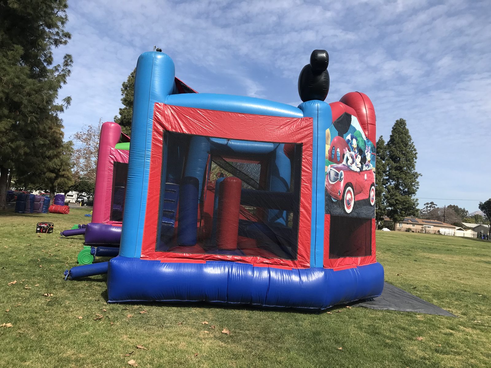 5n1 Mickey combo bounce house rental in San Diego, back corner view of the red and blue mesh walls