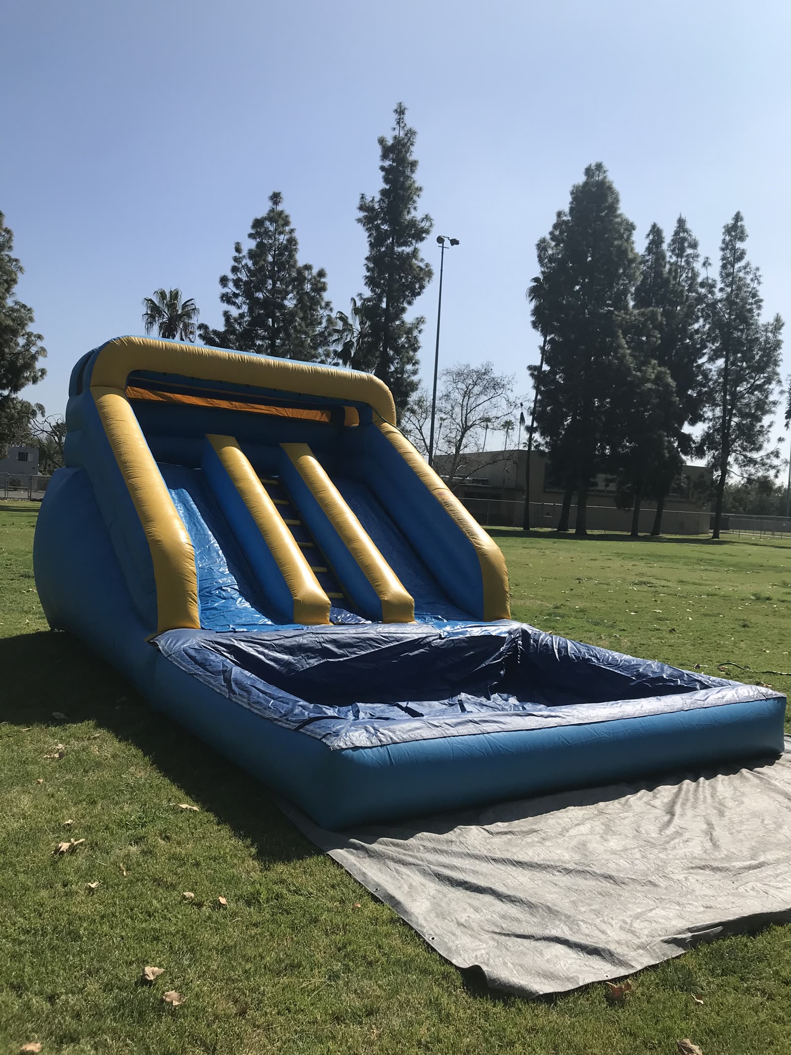 Mini water slide rental in San Diego, 12ft mini dual lane slide side view showing the full splash pool and ground tarp
