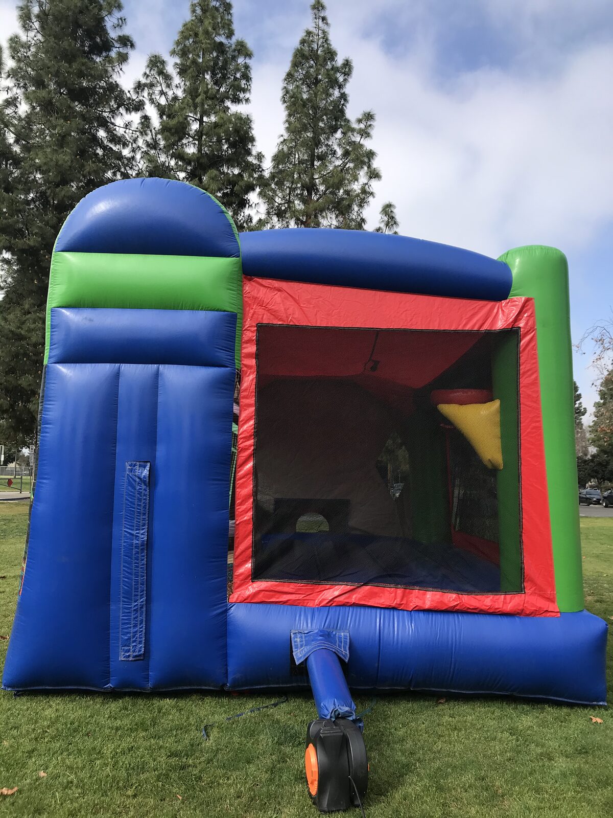 4n1 Toy Story combo bounce house rental in San Diego, back view of the blue slide and mesh jump area with the blower hooked up