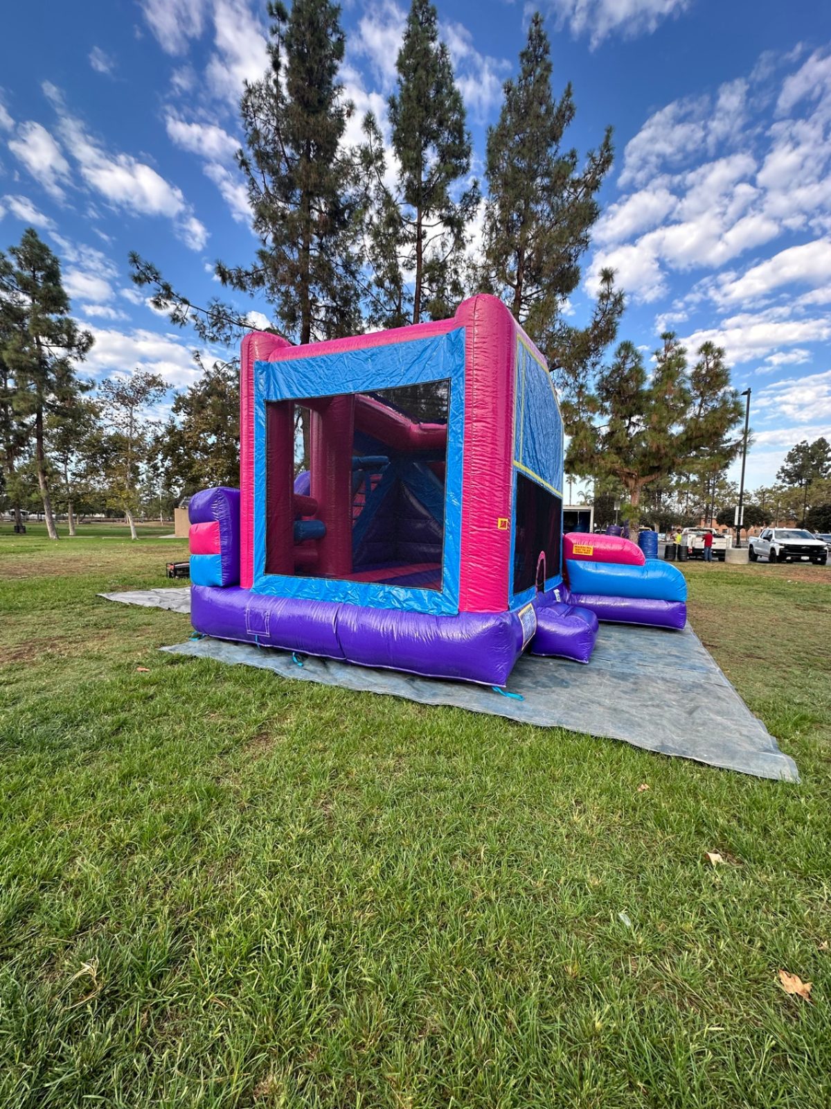 6n1 pink banner combo bounce house rental in San Diego, corner view of the mesh window and obstacles inside