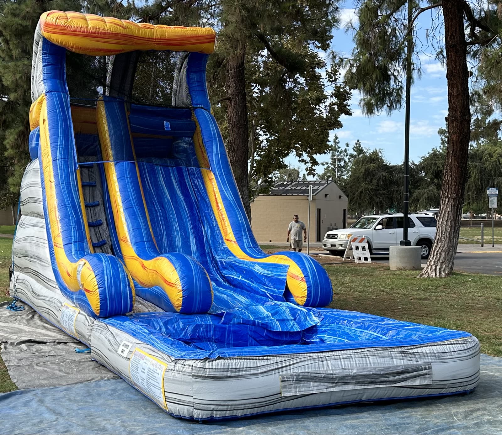 Water slide rental in San Diego, 18ft tidal wave setup side profile showing the full slide lane and gray marble tower