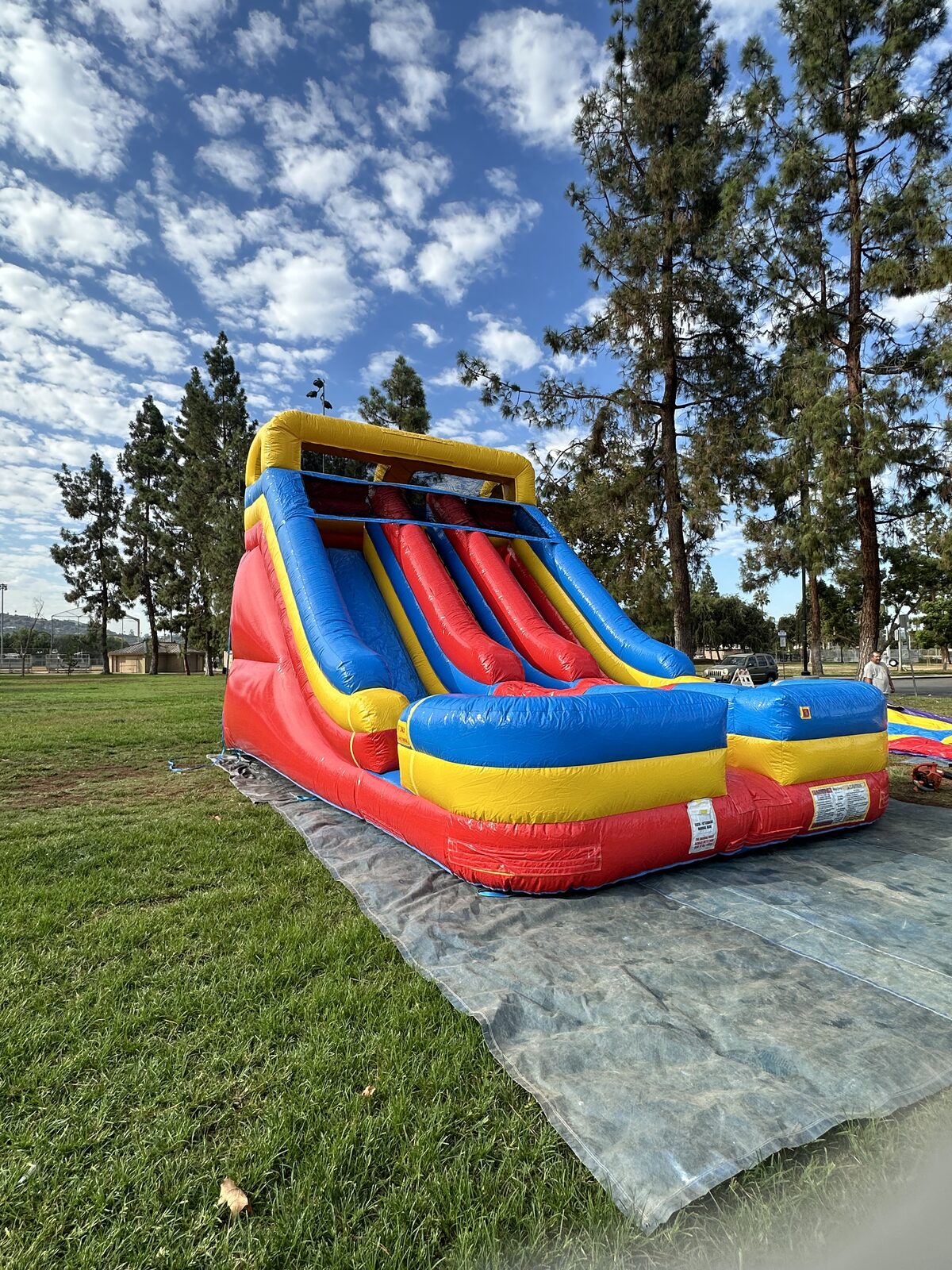 Dry slide rental in San Diego, 18ft dual lane slide side view showing the climbing lane and full height