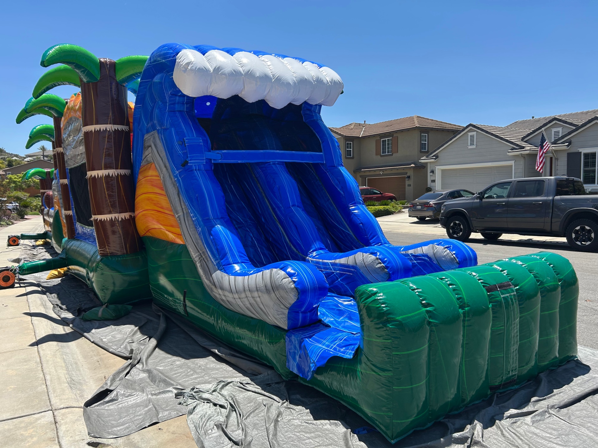 63ft tropical obstacle course rental in San Diego, slide lanes and green run-out landing bumper