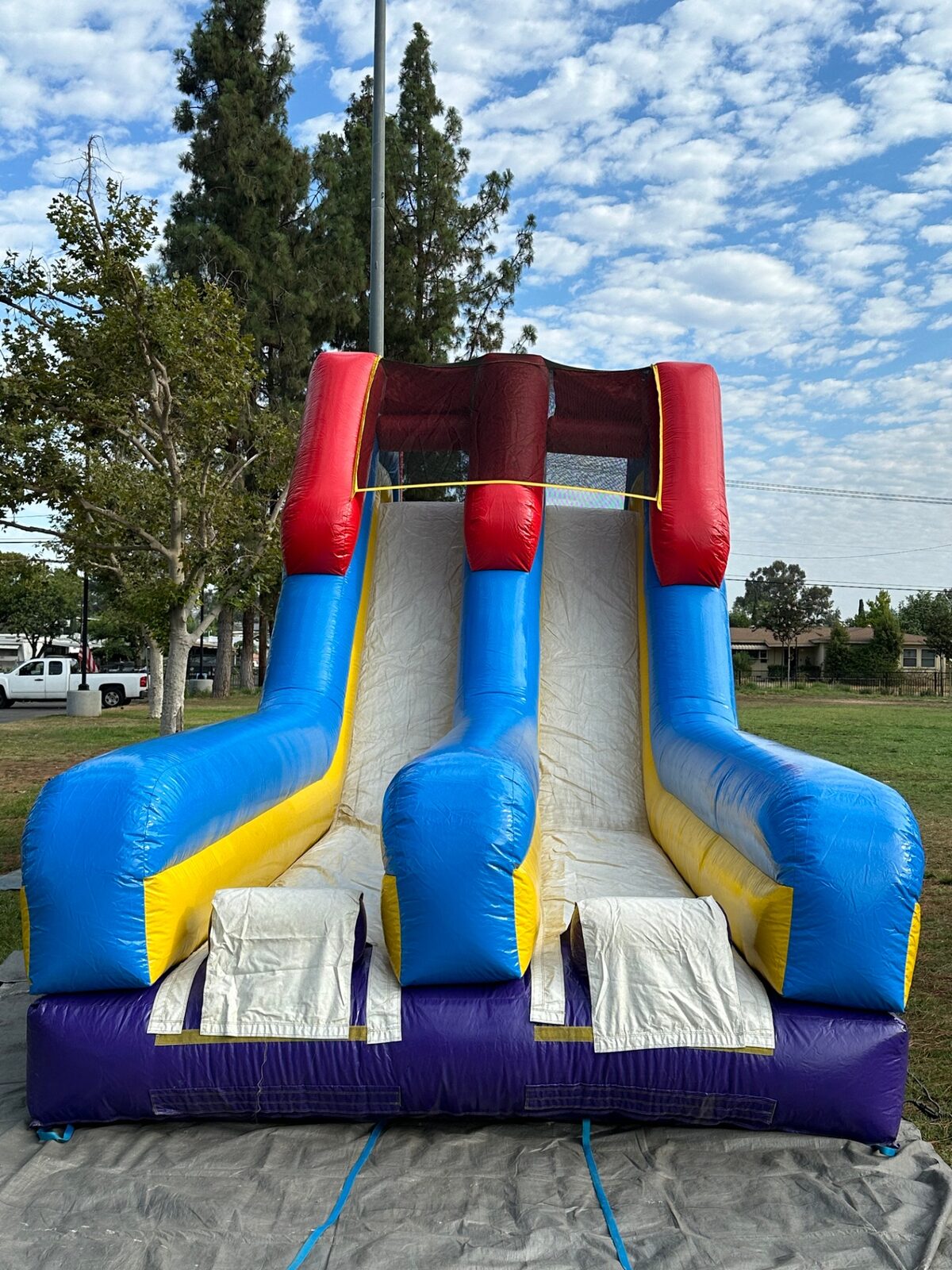 18ft dual lane monster obstacle course rental in San Diego, straight-on view of both slide lanes and landing mats