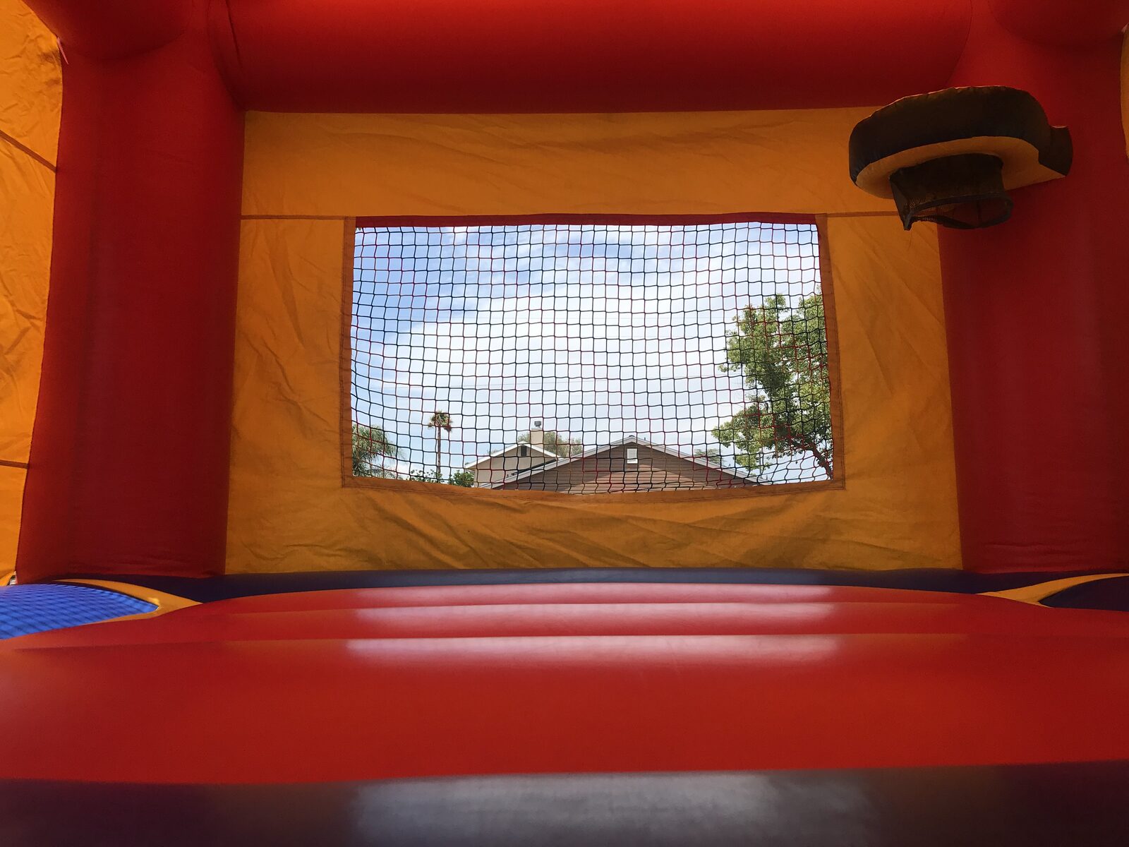 13x13 regular castle bounce house rental in San Diego — side view of the castle set up for a backyard party