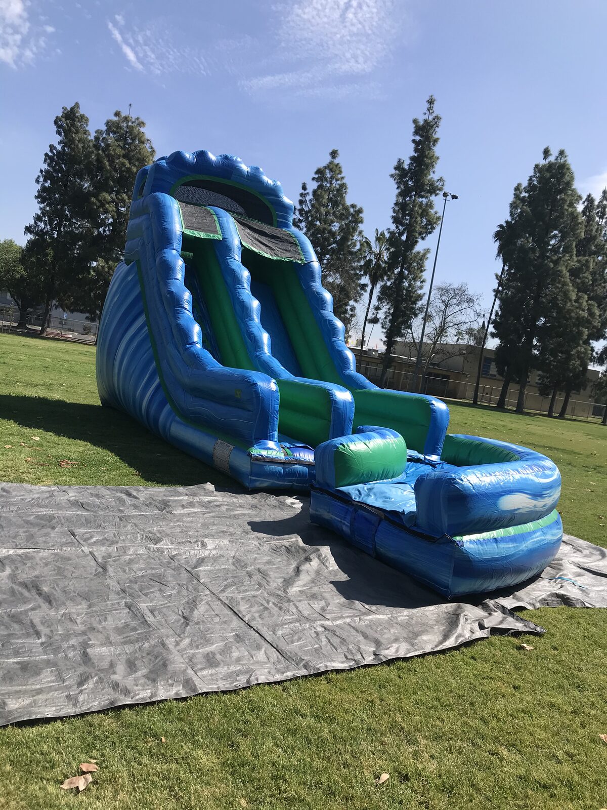 Dry slide rental in San Diego, 20ft green and blue setup vertical view showing the slide's full height