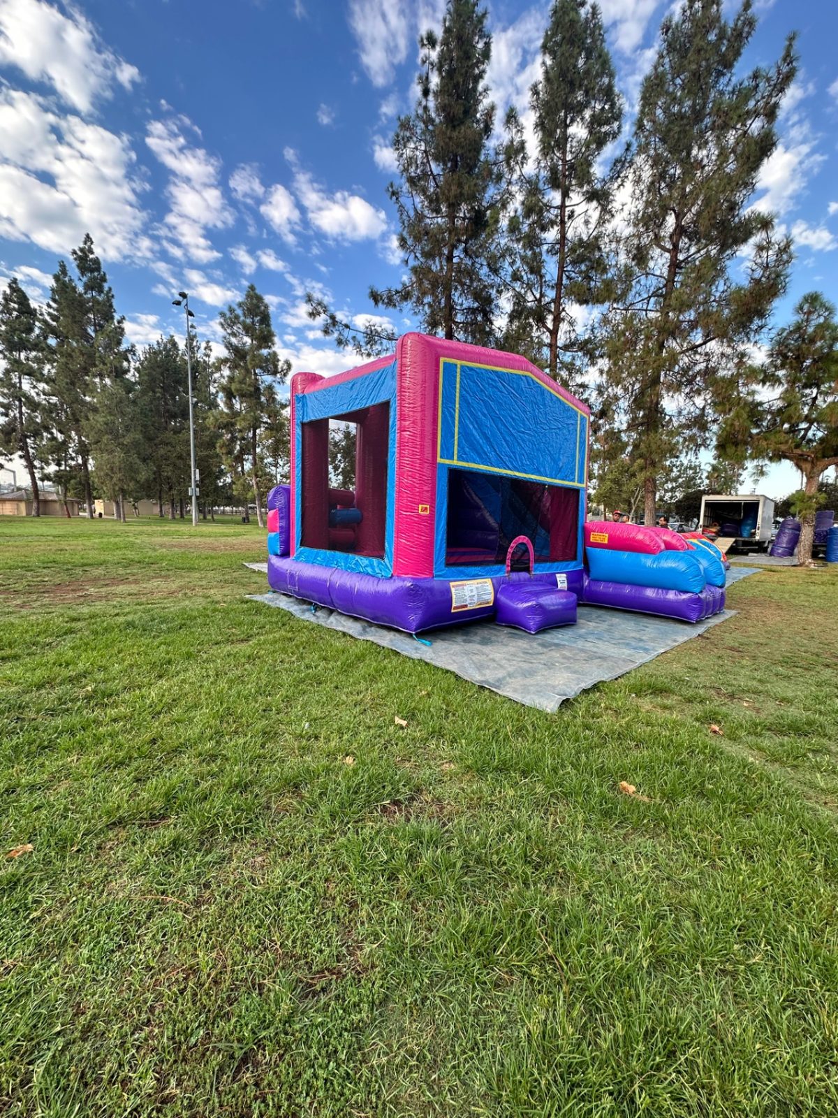 6n1 pink banner combo bounce house rental in San Diego, side view of the banner panel, entry step and slide landing