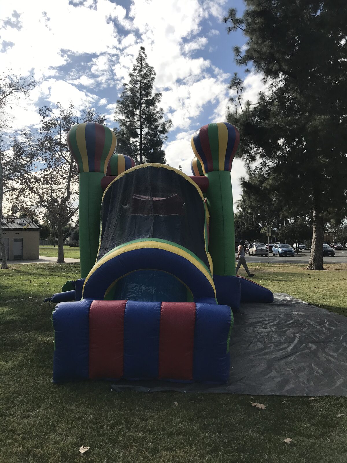 4n1 balloon castle combo bounce house rental in San Diego, head-on view of the slide exit framed by balloon towers