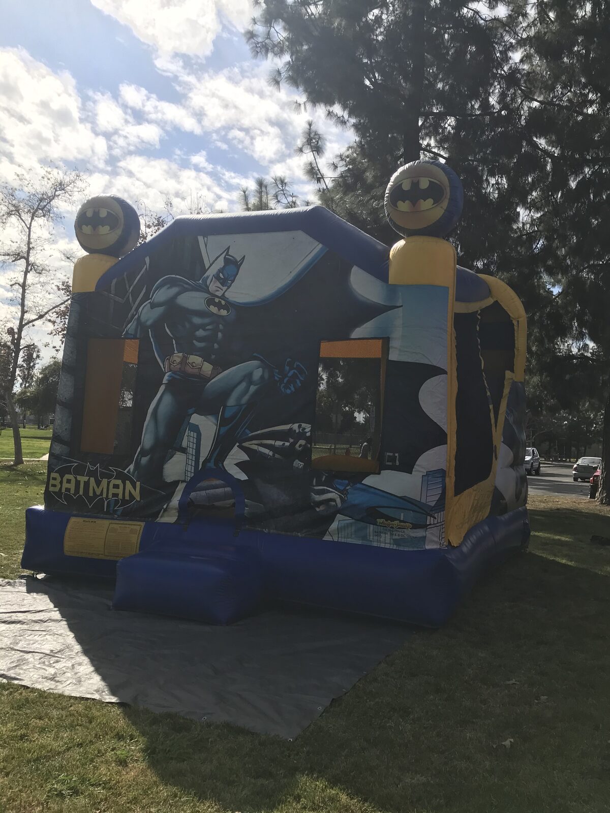4n1 Batman combo bounce house rental in San Diego, angled view of the Batman panel and side mesh windows
