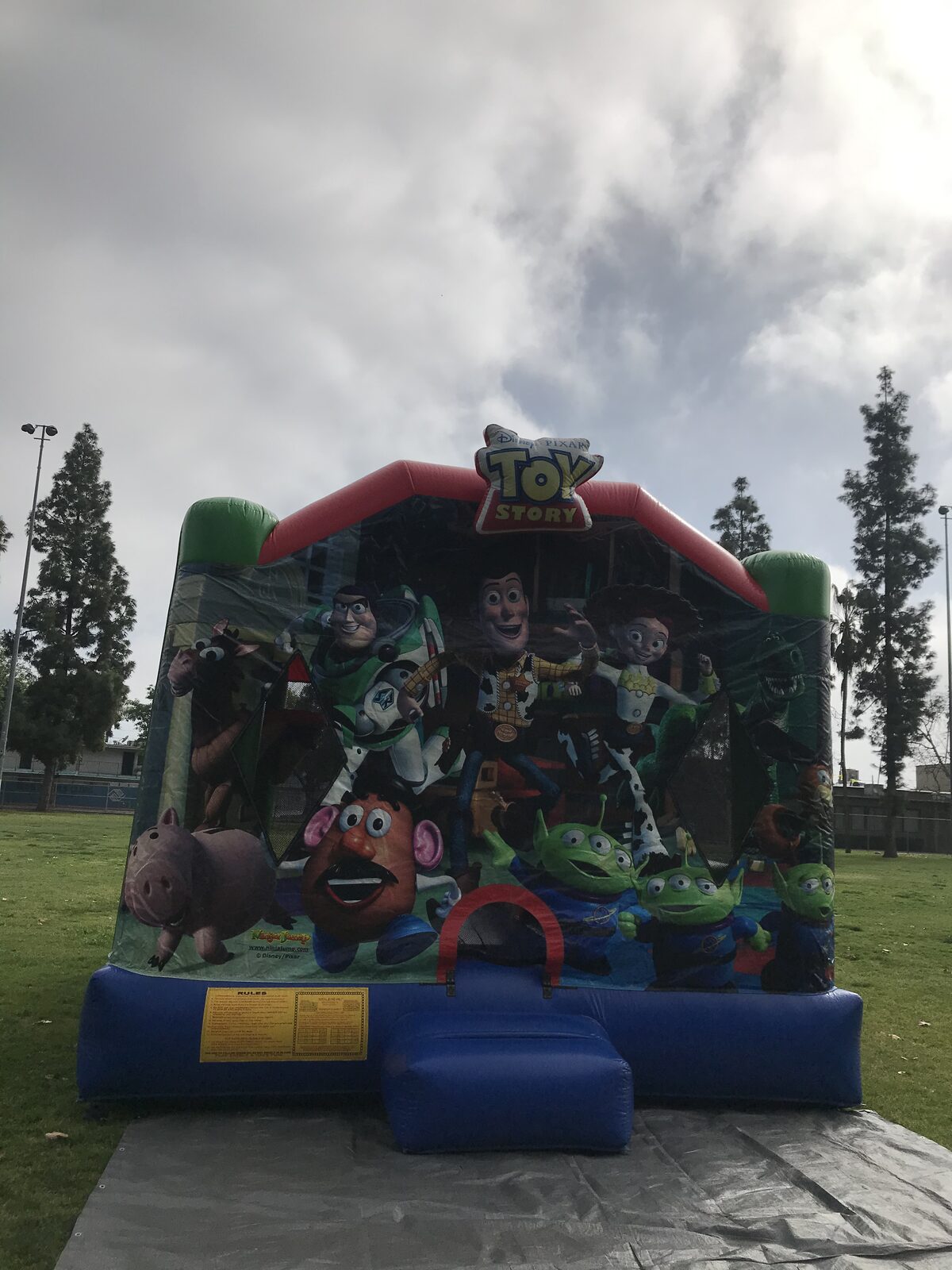 4n1 Toy Story combo bounce house rental in San Diego, close front view of the character panel and blue entry step